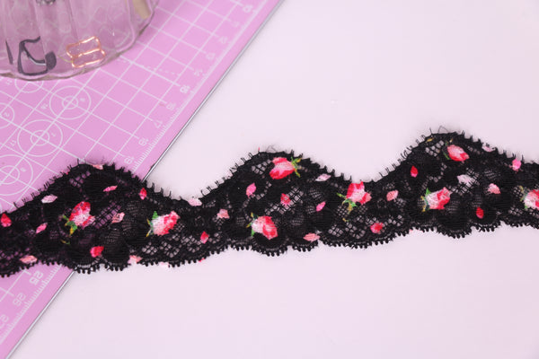Cinta de encaje elástico negra con flores rosas.